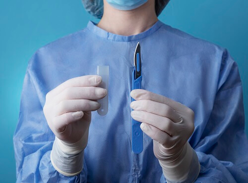 female-doctor-holding-metallic-medical-scalpel