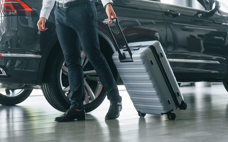 partical-view-man-formal-clothes-is-with-luggage-indoors-near-car_146671-62912